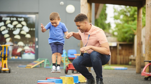 Early childhood teacher takes student through steps