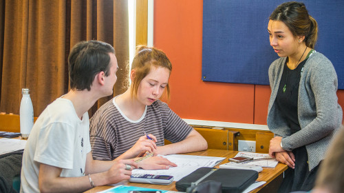 Teacher advises two students in STEM class