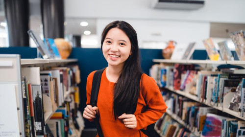 Student smiles while in library