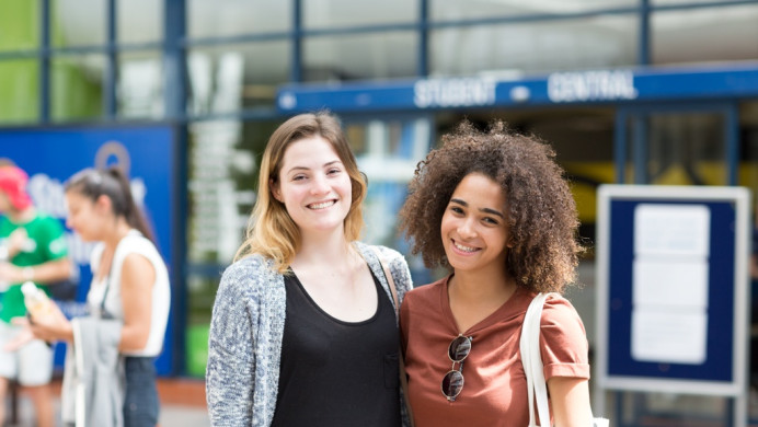 Two international students smile