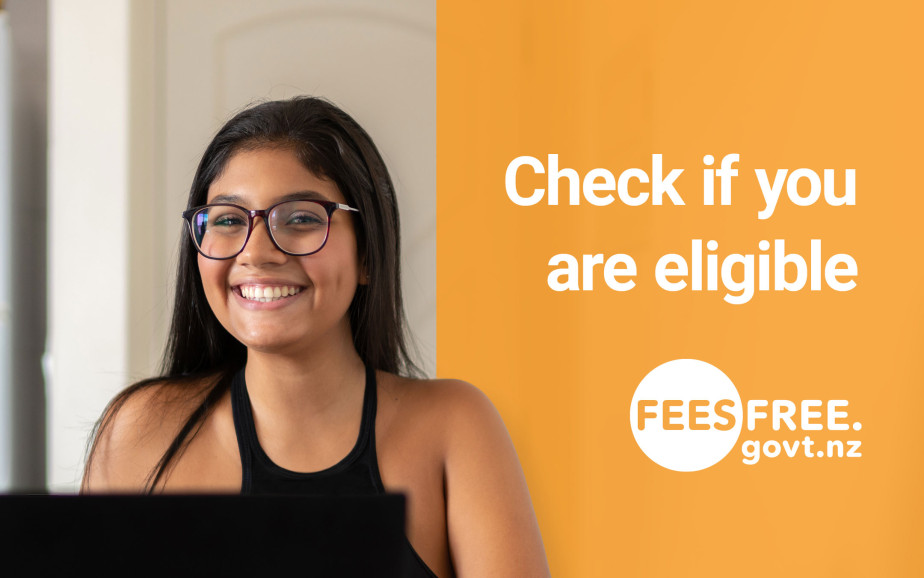 A woman smiles while using a computer. The text on the image reads 'Check if you are eligible feesfree.govt.nz'