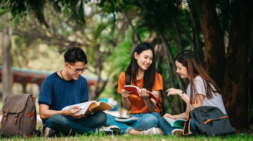 Three people studying outside