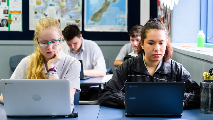 Students sitting an online exam in a classroom