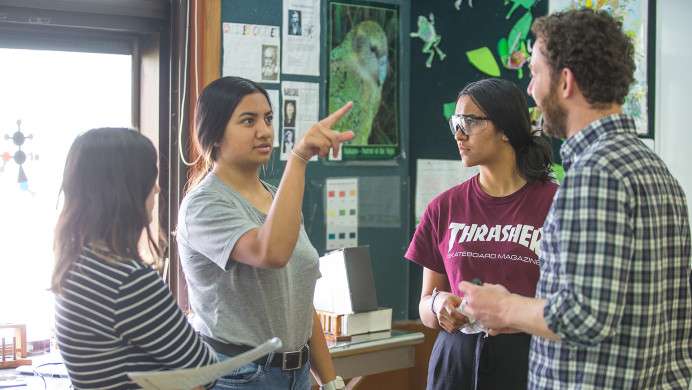 Wellington High School students talk to their teacher