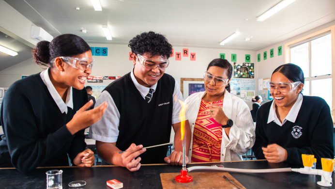 Three Pasifika students are in a classroom performing a science experiment