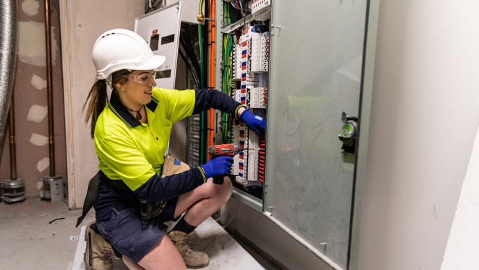 Electrical apprentice checks fuses