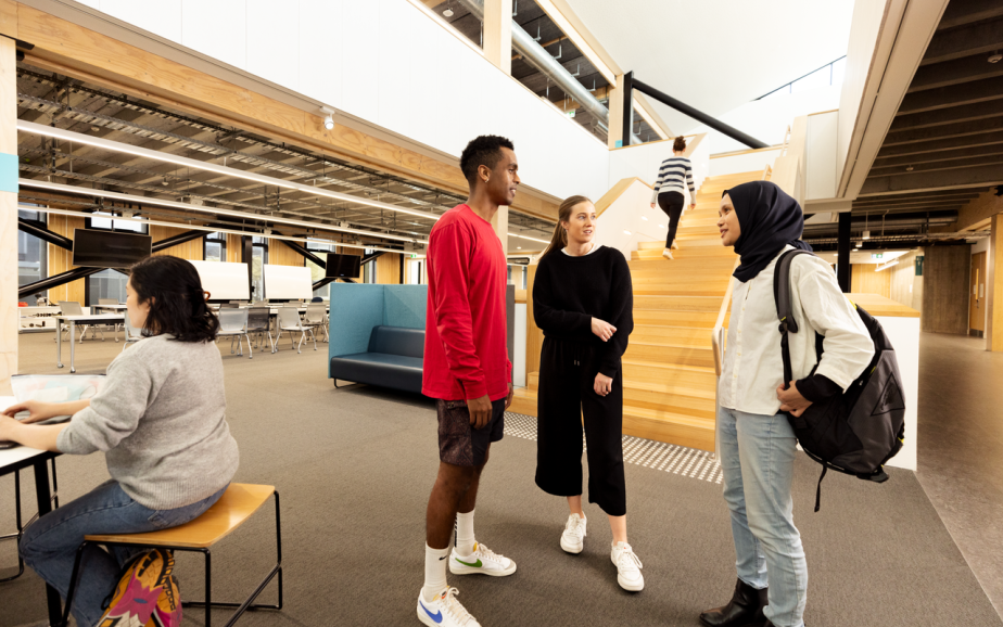 Three students stand in the hallway of their tertiary institution