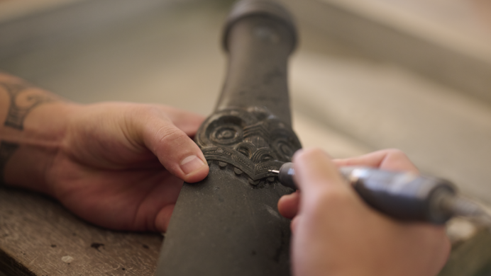 A student carves a piece of clay
