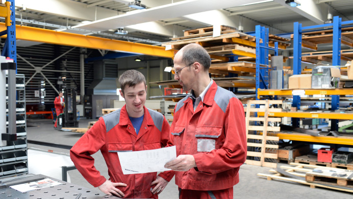 A staff member at a TEO shows the EER evaluator the company's processes