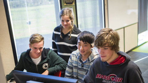 Four students look at a screen