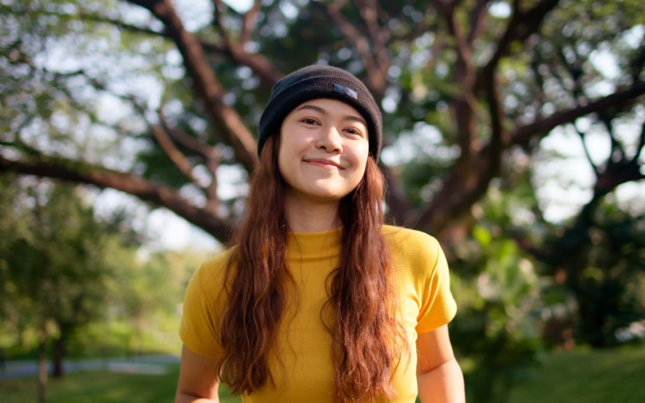 A young woman stands in the park