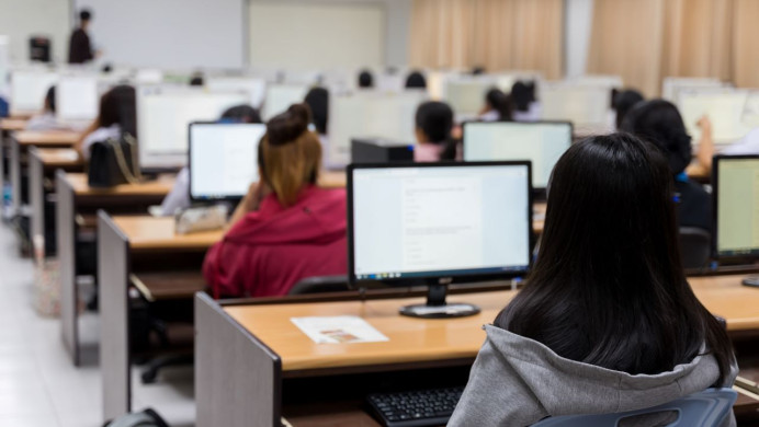 students sit a digital exam